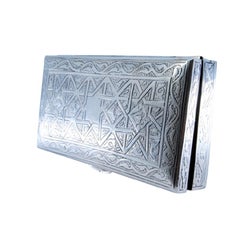 Silver tobacco box with Islamic-style reliefs and a wood-lined interior