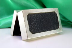 Silver tobacco box with raised floral motifs, monogram and wood lining