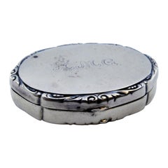 Silver toiletry box w/ mirror inside & bordered w/ a trim on the hinged lid