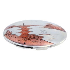 Silver toiletry box with Asian motifs engraved on the lid and mirror inside