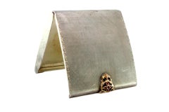 Silver toiletry box with gold clasp and synthetic stones and mirror inside