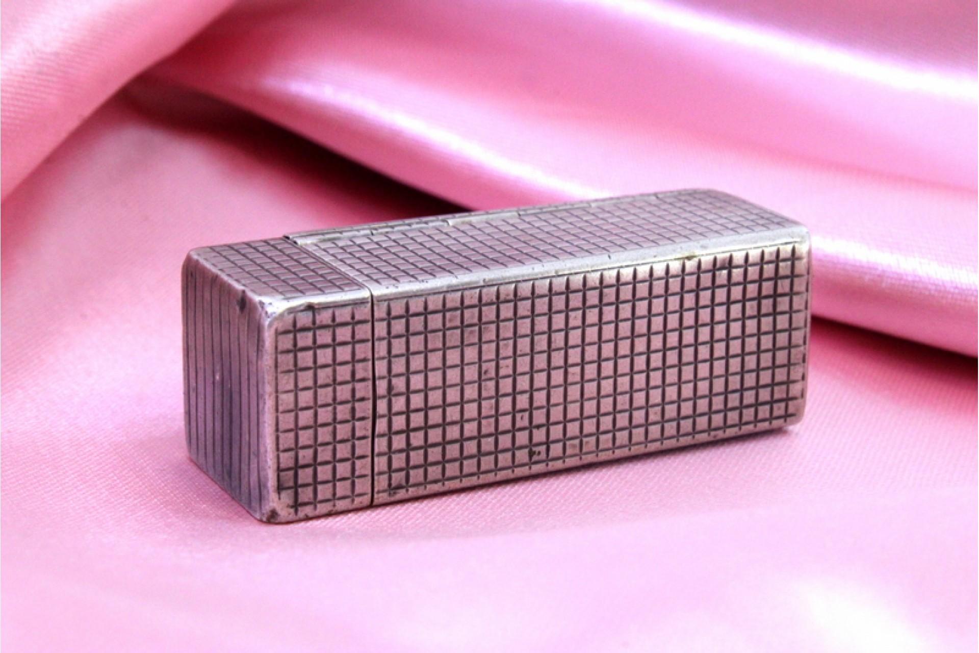 Description: Silver toiletry box with lipstick holder and mirror with removable lid. Metal: Silver. Origin: European. Brand: Unknown. Weight: 29.9 grams. Dimensions: 5.3cm x 1.9cm. Content: 800/1000. Assay Mark: Yes. Additional information: Signs of