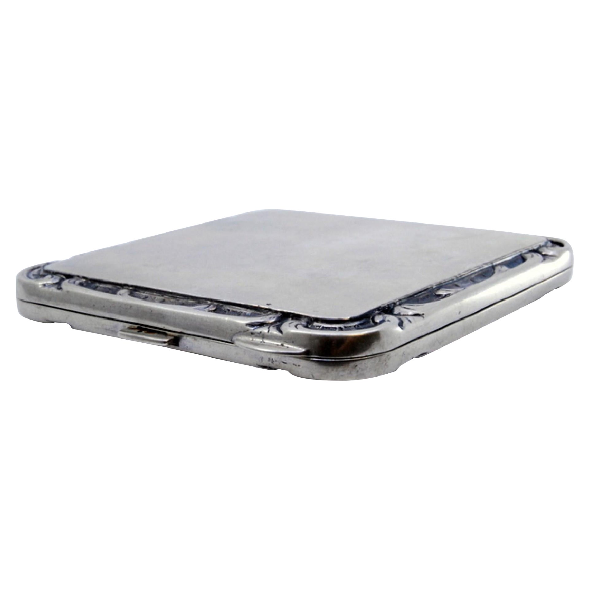 Silver toiletry box with shell-shaped border and mirror inside