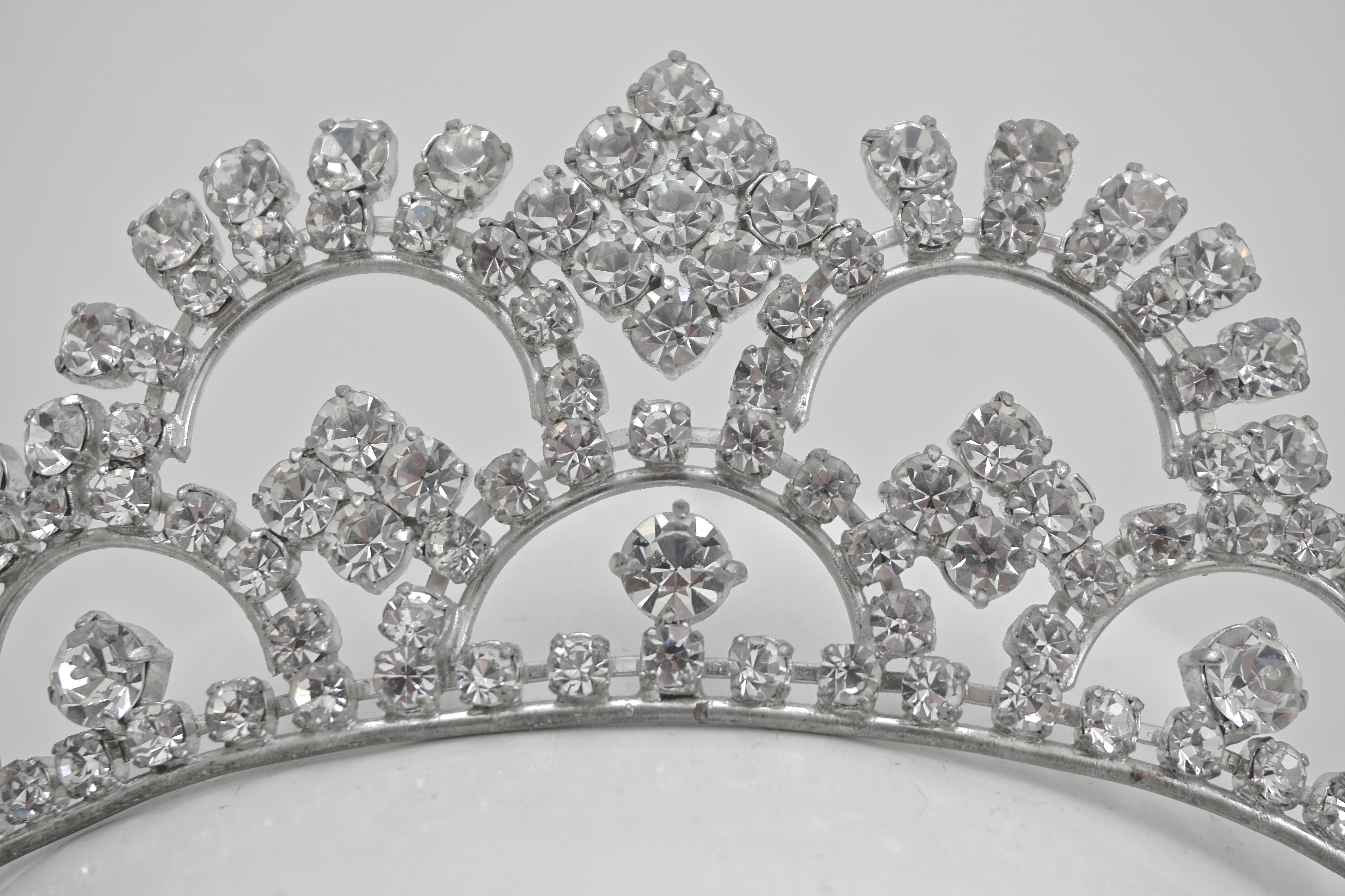 Fabulous silver tone tiara set with clear sparkling faceted rhinestones, circa 1950s. This is a well made quality tiara in a classic design, made to sit on top of the head. Measuring height 5cm / 1.97 inches, the large rhinestones are all prong set.