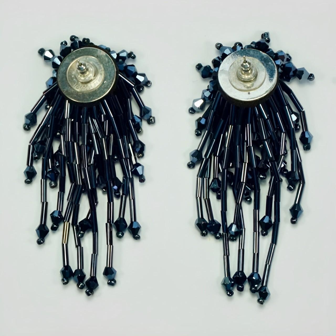 Beautiful silver tone earrings, featuring grey glass beads. There is a cluster of beads at the top and long strands of beads dangle from the top. Measuring length approximately 8 cm / 3.1 inches. There is scratching to the silver tone. One strand is
