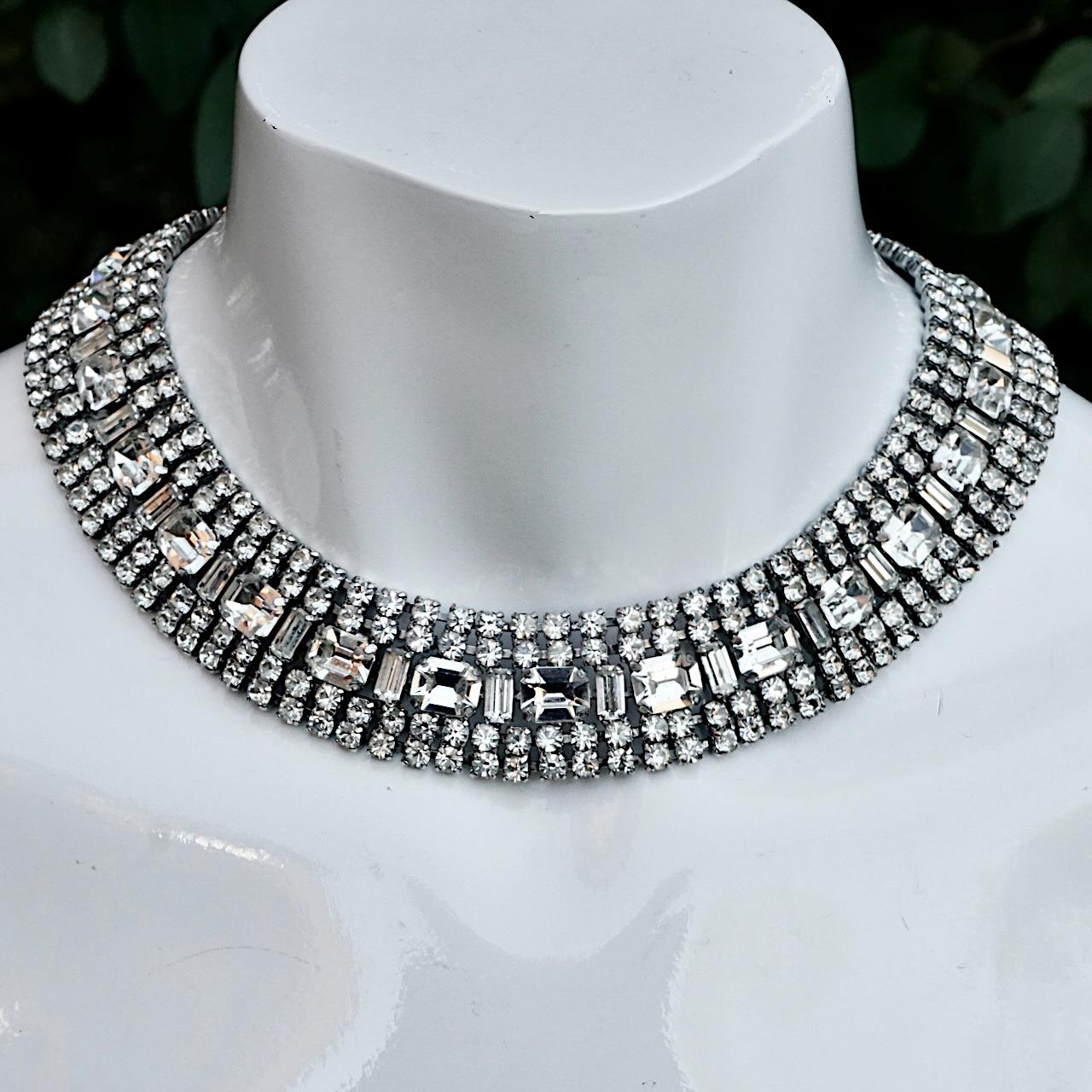 Wonderful silver tone collar / necklace set with clear sparkling baguette, emerald cut and round rhinestones. It is a small size measuring inside length 37cm / 14.56 inches by width 2.3 cm / .9 inch. The necklace is slightly curved and sits