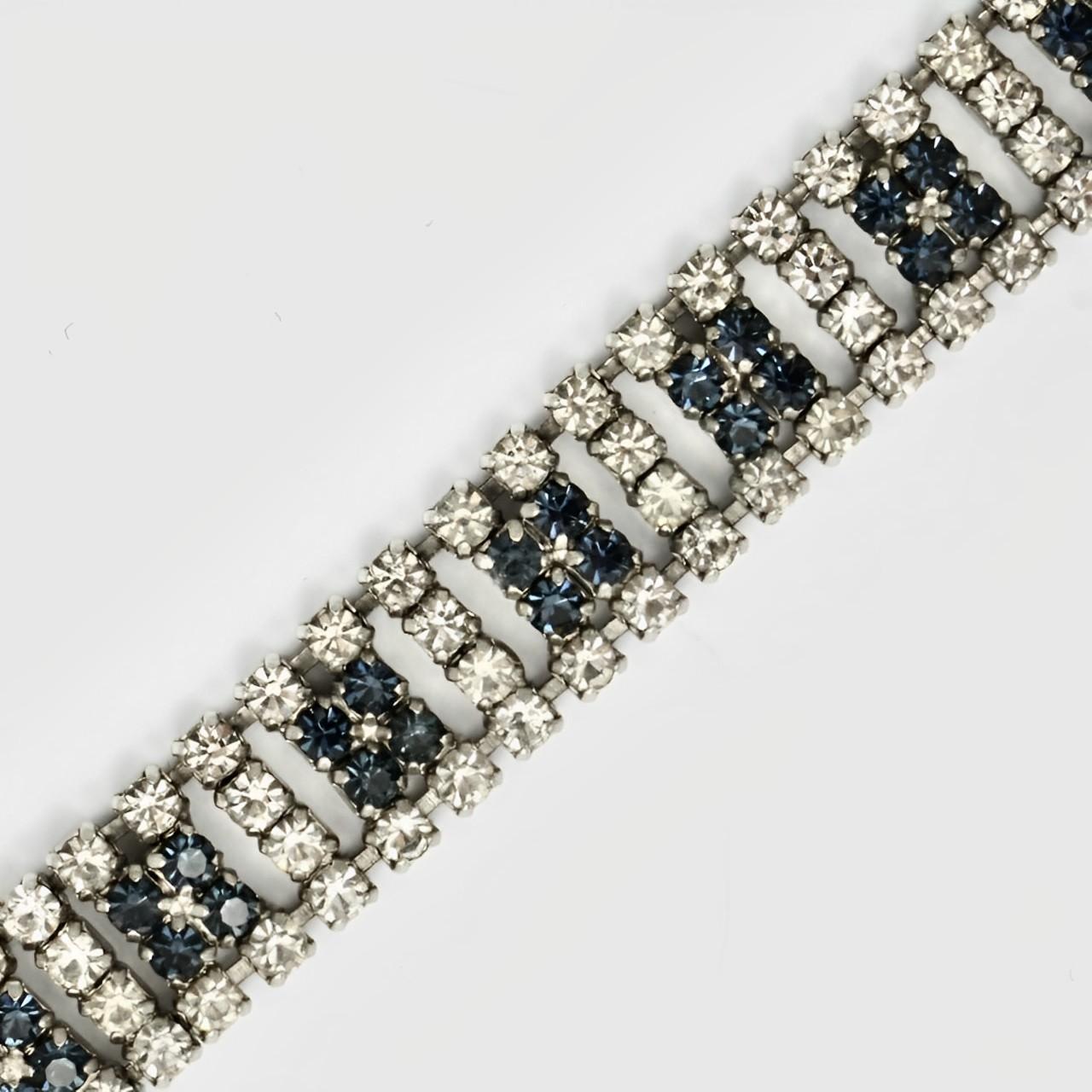 Lovely silver tone bracelet, with sparkling blue and clear rhinestones. Measuring length 17.3 cm / 6.8 inches by width 1.25 cm / .49 inch. There is one replacement rhinestone.

This is a beautiful vintage bracelet for the evening or a special