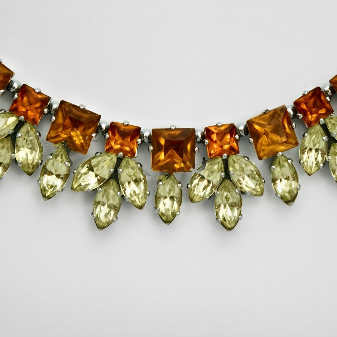 Beautiful silver tone collar / necklace set with orange and lemon rhinestones strung on to wire. Each rhinestone section is separated by a silver tone ball. It is a small size measuring inside length approximately 38 cm / 15 inches by width 2 cm /