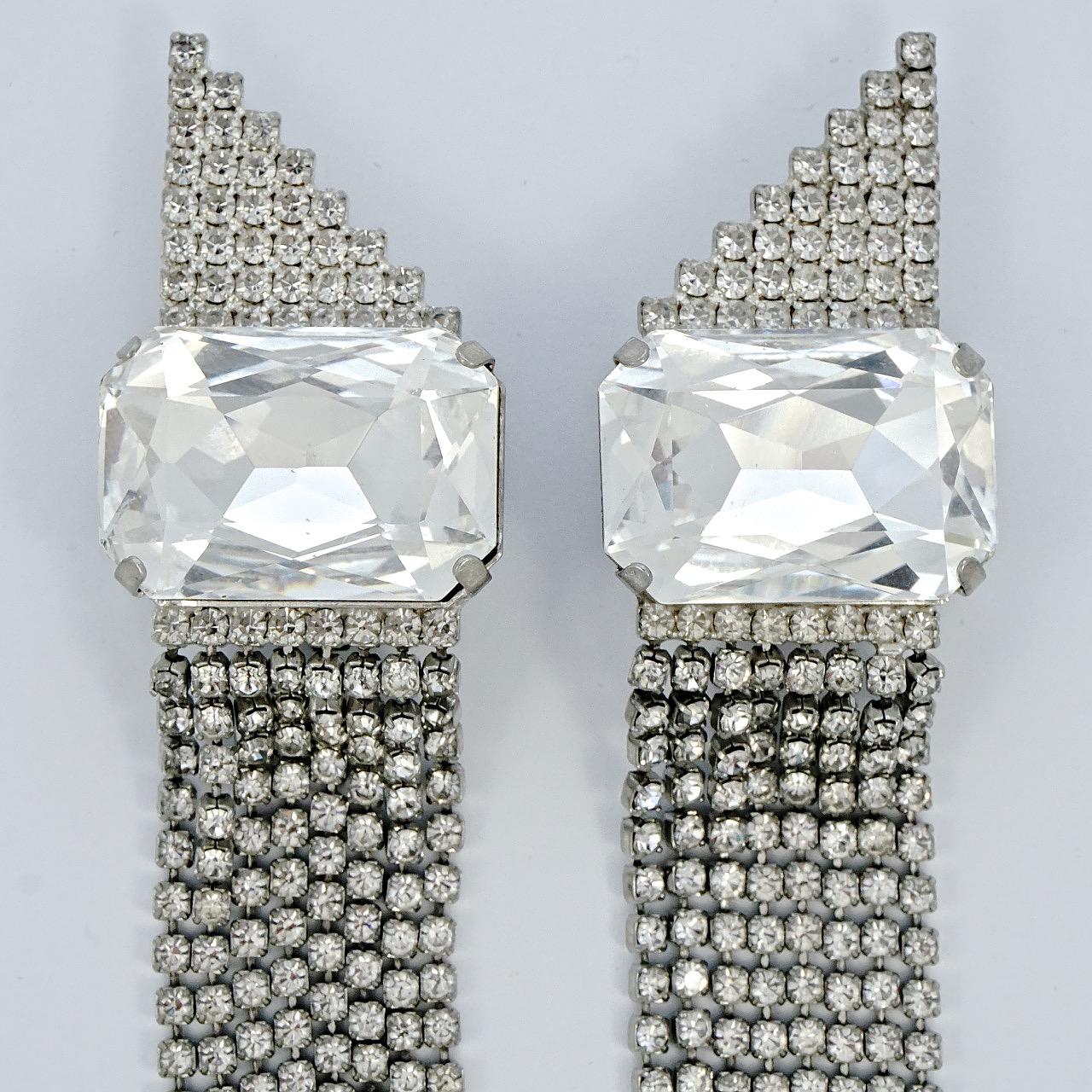 Fabulous silver tone chandelier clip on earrings, with eight strands of sparkling clear rhinestones dropping from a large single rhinestone. Measuring length 13.8cm / 5.4 inches, and the single rhinestone is 2.7cm / 1 inch by 1.8cm / .7 inch. There