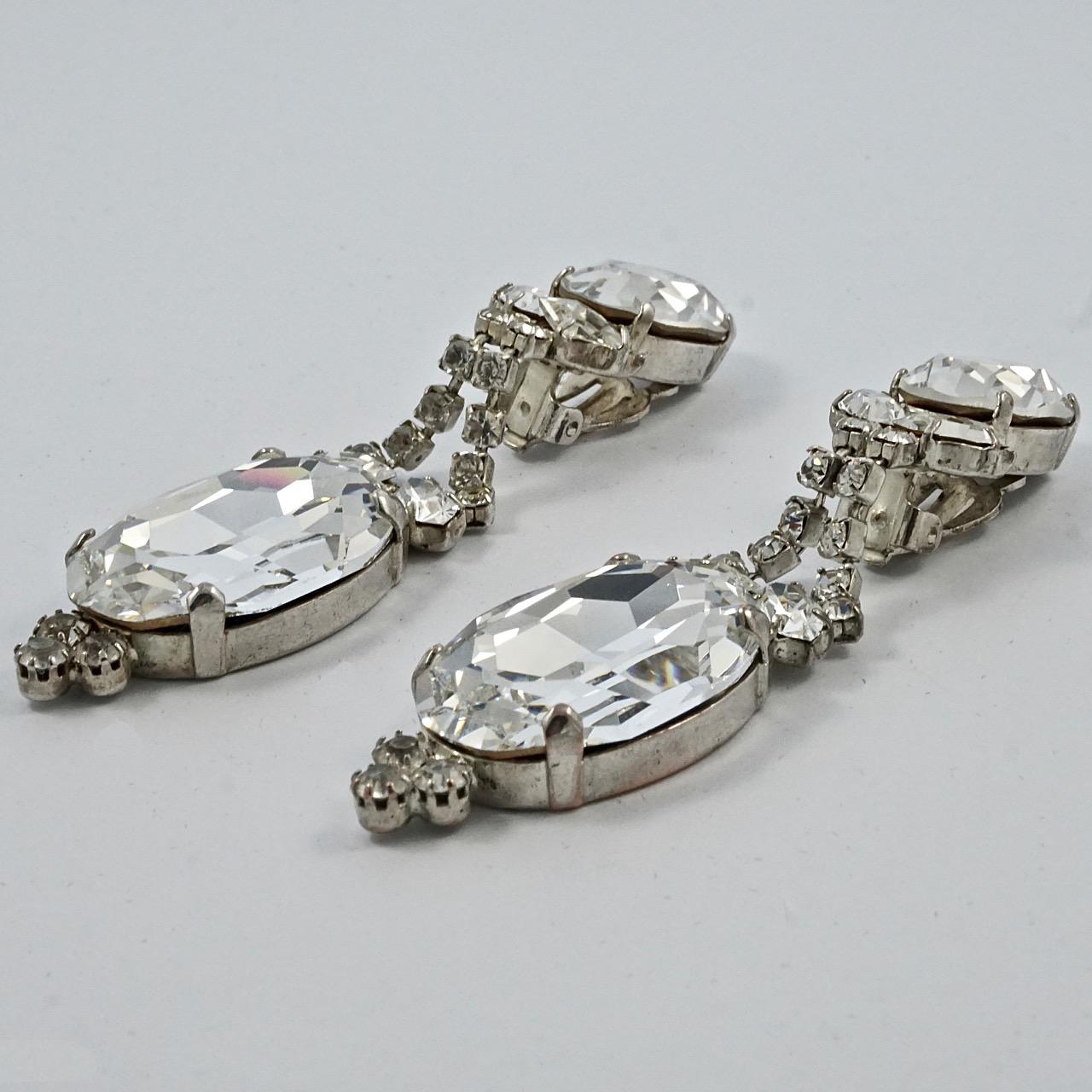 Fabulous silver tone clip on statement earrings, with sparkling clear rhinestones. Measuring length 8.5cm / 3.3 inches, and the large drop is width 2.1cm / .8 inch.

These are beautiful vintage drop earrings for the evening or a special occasion.