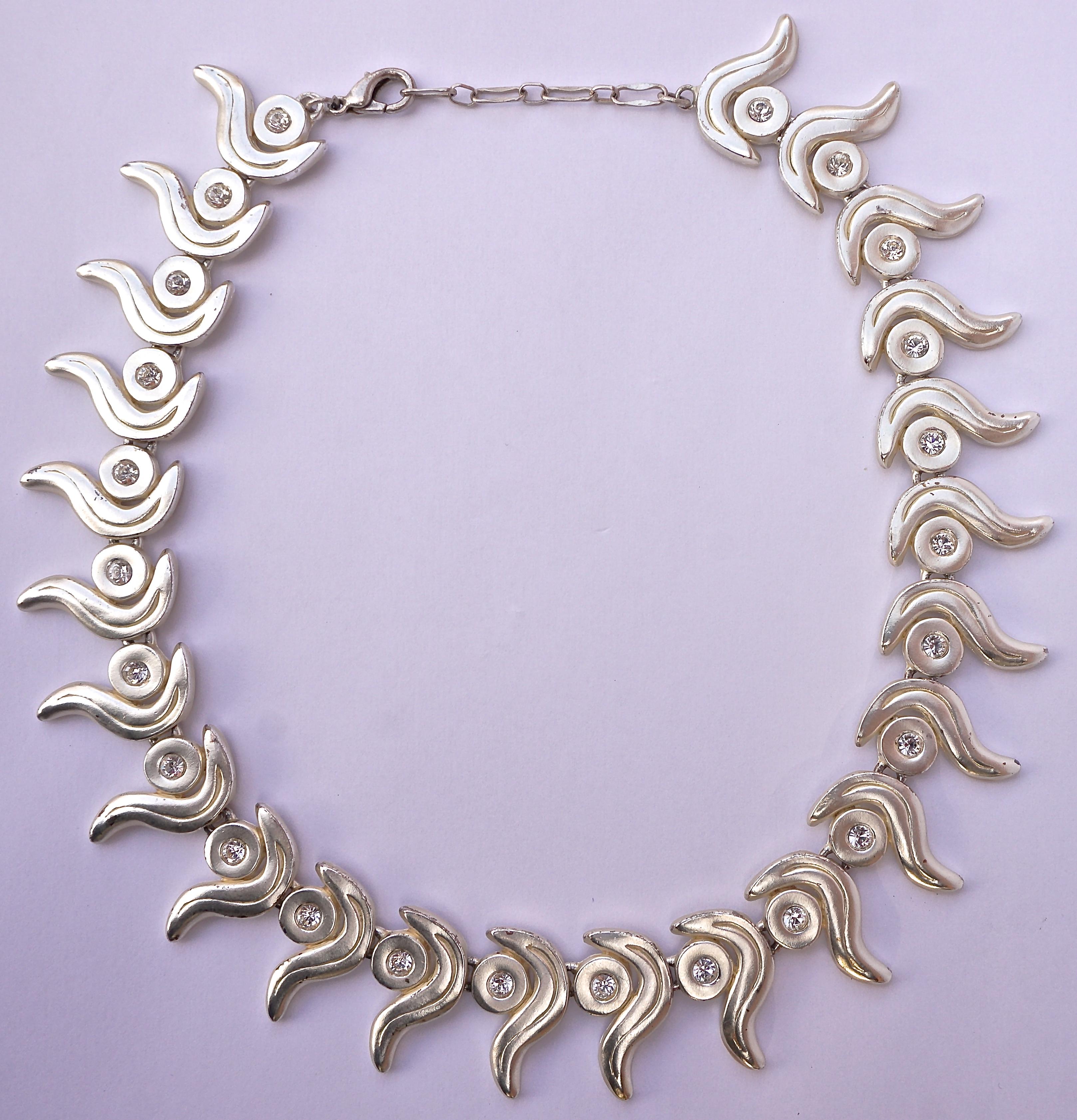 Matt silver tone necklace and clip on earrings featuring a lovely swirl design set with clear rhinestones. The reverse is shiny silver tone. Measuring length 40.5cm / 15.94 inches, plus an extension of 3.5cm / 1.38 inch. The links are length 2.6cm /