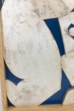 Silver-toned bas-relief panel titled “The Acrobat” on a blue background. Contemp