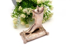 Silver toothpick holder in the shape of a boot
