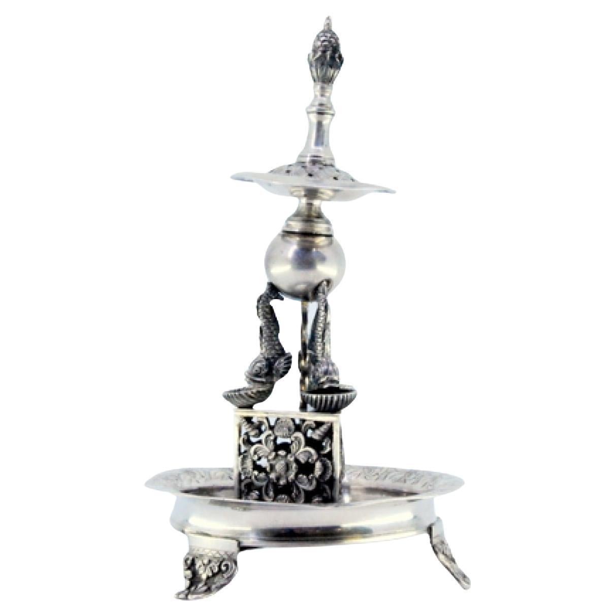 Silver toothpick holder in the shape of a fountain with fish