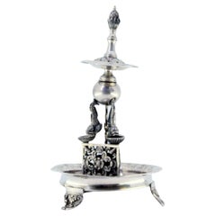 Silver toothpick holder in the shape of a fountain with fish