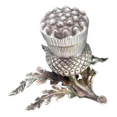 Silver toothpick holder in the shape of a pineapple w/ cut-out leaf applications