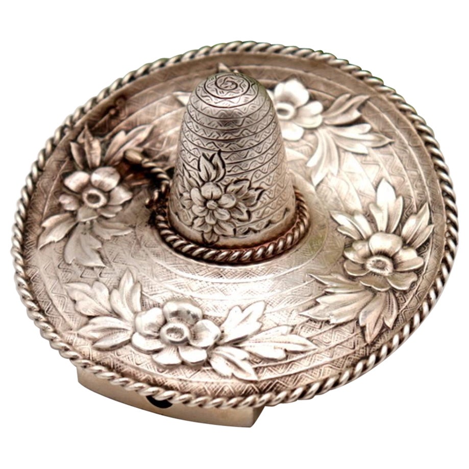 Silver toothpick holder in the shape of a sombrero with reliefs and applications