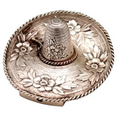 Silver toothpick holder in the shape of a sombrero with reliefs and applications