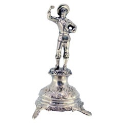 Silver toothpick holder w/ figure of nobleman w/ chalice standing on a plinth
