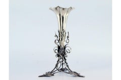 Silver toothpick holder w/ flower-shaped chalice & resting on a flowerpot plant