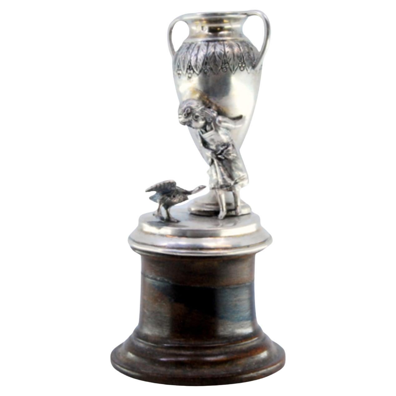 Silver toothpick holder with a girl supporting an amphora on a wooden base
