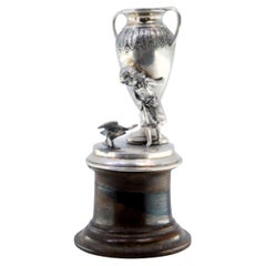 Silver toothpick holder with a girl supporting an amphora on a wooden base