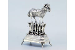 Silver toothpick holder with a lamb on a pedestal