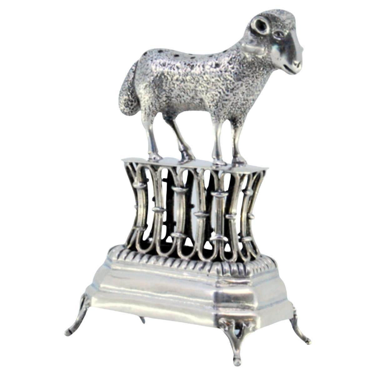 Silver toothpick holder with a lamb on a pedestal