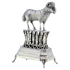 Silver toothpick holder with a lamb on a pedestal