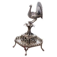 Silver toothpick holder with a peacock in perfect shape on a plant