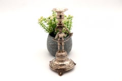Silver toothpick holder with boy on a pedestal with reliefs