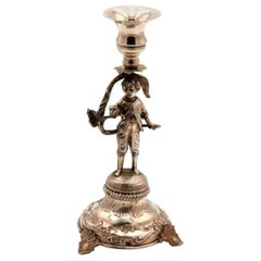 Silver toothpick holder with boy on a pedestal with reliefs