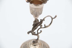 Silver toothpick holder with chalice over mythological figure in relief