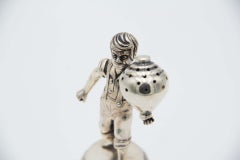 Silver toothpick holder with child playing spinning top