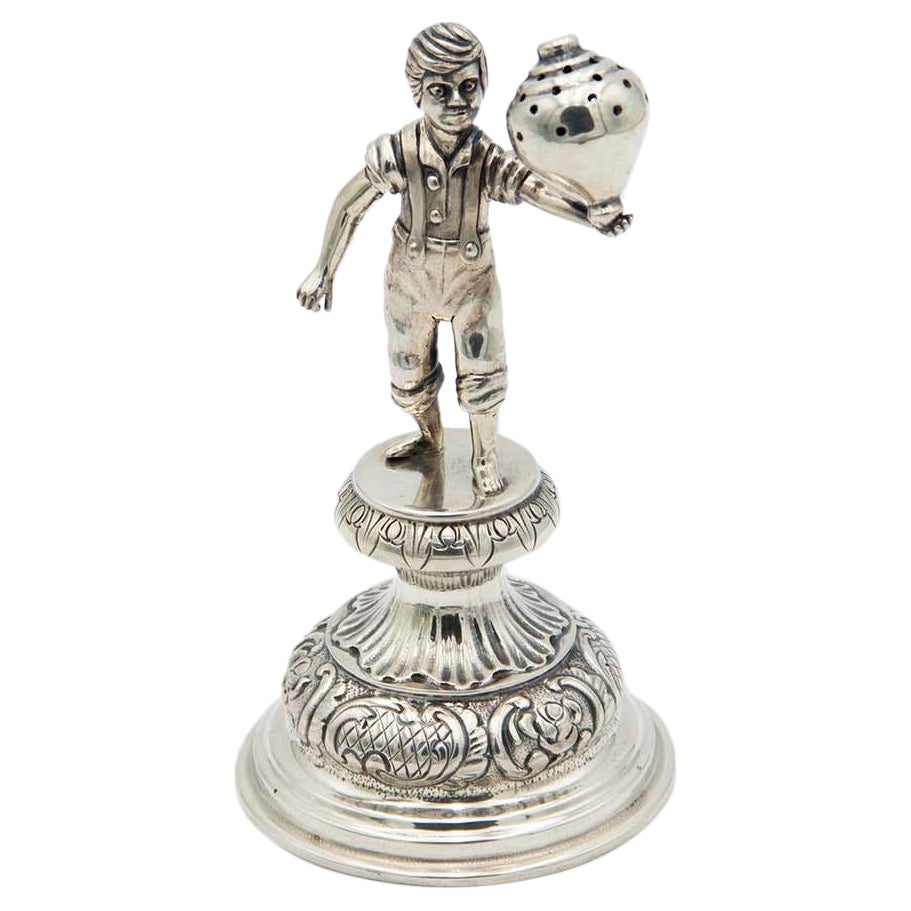 Silver toothpick holder with child playing spinning top