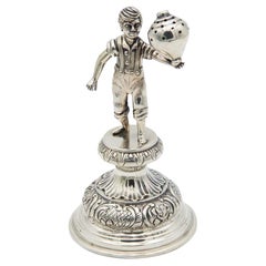 Silver toothpick holder with child playing spinning top