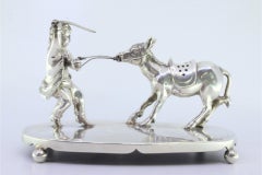 Silver toothpick holder with child pulling donkey on smooth base with four feet