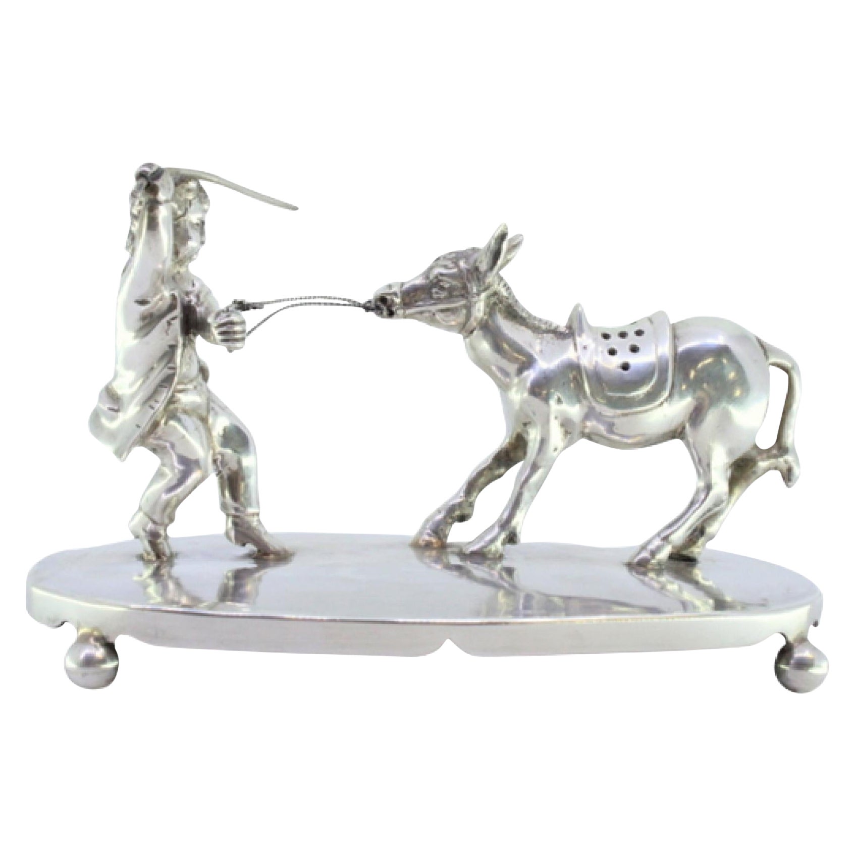Silver toothpick holder with child pulling donkey on smooth base with four feet