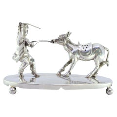 Silver toothpick holder with child pulling donkey on smooth base with four feet
