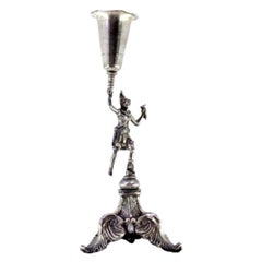 Silver toothpick holder with figure on ball on raised plinth with three feet