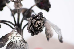 Silver toothpick holder with flowered flowerbed bulb on circular base