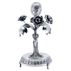 Silver toothpick holder with flowers, leaves, walnut center, and three feet