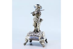 Silver toothpick holder with flutist standing on a plinth