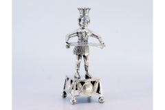 Silver toothpick holder with Indian holding tray and resting on a cut-out plinth
