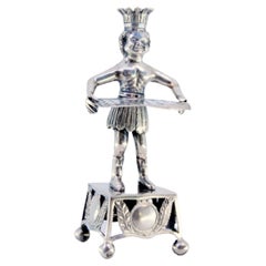 Silver toothpick holder with Indian holding tray and resting on a cut-out plinth