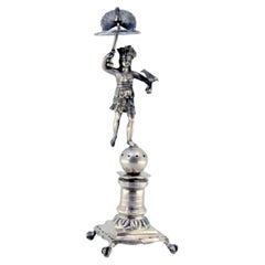 Silver toothpick holder with indigenous figure holding bird and peacock on head