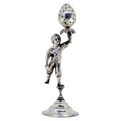 Silver toothpick holder with male figure holding strawberry on engraved base
