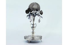 Silver toothpick holder with peacock perched on a flowering bush