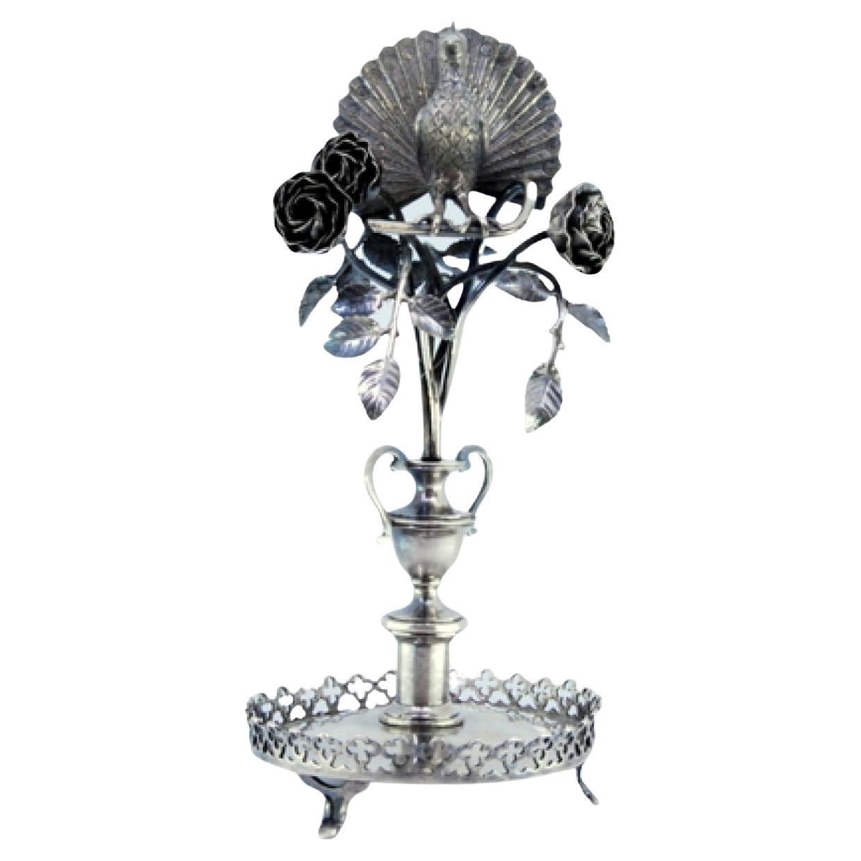 Silver toothpick holder with peacock perched on a flowering bush