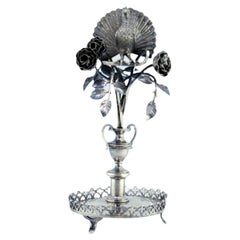 Silver toothpick holder with peacock perched on a flowering bush